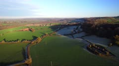 High wide shot of ramparts of Cadbury Hill on a cold sunny day with long shadows