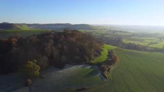 High wide shot of ramparts of Cadbury Hill on a cold sunny day with long shadows