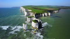 Aerial shot ascending and reversing from White cliffs and limestone stacks at Old Harry Rocks, Dorset, UK