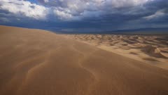 Gobi desert dunes with stormy sky in background