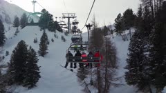 Snowboarder going up the ski lift at La Plagne ski resort, Tarentaise, Savoy, French Alps, France, Europe