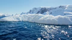Close up of icebergs and gentoo penguins roaming around in Antarctica, Polar Regions