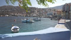 Small boats in bay and Symi Town, Symi Island, Dodecanese Islands, Greek Islands, Greece, Europe
