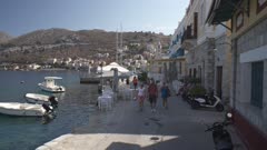 Boats and cafes along quayside in Symi Town, Symi Island, Dodecanese Islands, Greek Islands, Greece, Europe