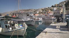 Boats and colourful houses and quayside in Symi Town, Symi Island, Dodecanese Islands, Greek Islands, Greece, Europe
