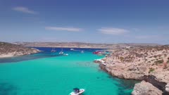 Aerial panoramic drone footage of Pure crystal water of the famous Blue Lagoon on the Maltese Island of Comino, Malta, Mediterranean, Europe