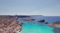 Aerial panoramic drone footage of Pure crystal water of the famous Blue Lagoon on the Maltese Island of Comino, Malta, Mediterranean, Europe