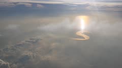 Aerial view sun ray over the cloud above the terrain and river