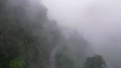 Aerial view road to the entrance of Chin Swee Caves Temple, Genting in misty foggy day