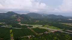 Aerial view interchange PLUS highway of Bandar Baharu Toll Plaza near oil palm farm