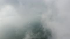 Aerial fly over morning low cloud toward the boat move at sea