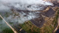 Aerial view landfill site caught fire at Malaysia. Noxious fumes from fire release