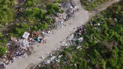 Aerial fly rotation rural path with illegal rubbish dump