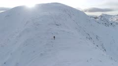 Mountain Climber Almost at the Summit of a Snowy Mountain