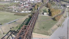 Commuter Train Passing Fast Over an Old Iron Bridge