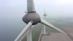 Aerial View of a Giant Wind Farm Used for Renewable Energy on a Foggy Day