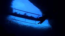 Native Free Diver Descends From Boat At Cave Opening