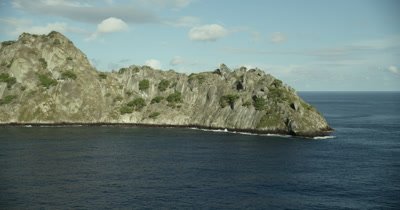 Approaching rock off island with cave inlet