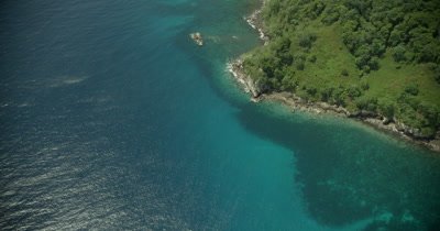 high angle show flying along coast of island, birds eye view