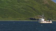 Fishing Boat Fish Tender Travels In Front Of Brilliant Green Aleutian Island Hillside