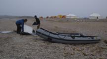 People Setting Up Inflatable Boat