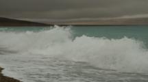 Waves Wash Up On Dark Sand Beach