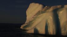 Melting Iceberg Glistens In Low Light