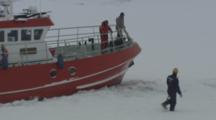 People Attempt To Free Boat Trapped In Ice And Snow