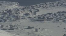 Overlooking Coastal Village In Rugged Snowy Arctic Landscape