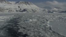 Backward Pov View From Boat Traveling Through Melt Ice Away From Shoreline