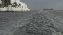 Small Boat Travels Through Channel In Melt Ice