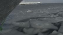 Small Boat Travels Through Channel In Melt Ice, View From Bow At Water Level