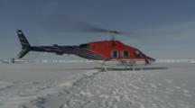 Helicopter Takes Off From Ice Field, Blows Snow On Camera
