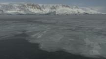 Arctic Greenland Coastline With Frozen Water In Foreground