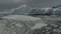 Travel Through Melt Ice Past Large Iceberg And Coastline