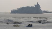 Sled Dog Team Passes Large Iceberg, Arctic Landscape