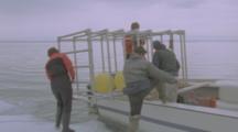 People Prepare Walrus Filming Cage On Boat