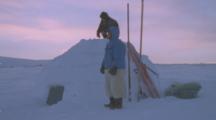 Two Inuit People Come Out Of Igloo