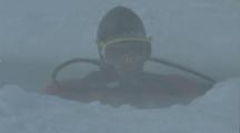 Diver In Dry Suit Descends Through Hole In Ice