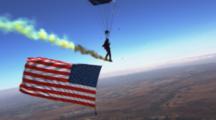 Navy Seal Sky Dives With Flag And Smoke Trail