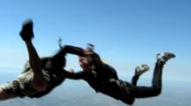 Two Skydivers In Free Fall Engaged In Mock Fighting
