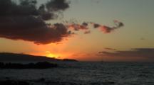 Sunset On Rugged Coast, Distant Sailboat