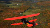 Aerial Of Bi-Plane Flying Over Forest, Countryside, Autumn Colors