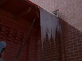 Man Removes Icicles From Building