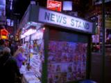 Walking By Newsstand In Times Square At Night