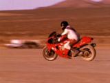 Man Rides Motorcycle In Desert