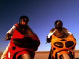 Two Men Ride Motorcycles In Desert