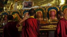 Young Monks In Front Of Buddhist Altar