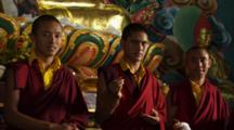 Young Monks Pose In Front Of Buddhist Altar
