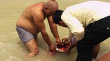 Men Offers Flowers During Ritual Bath In Ganges River